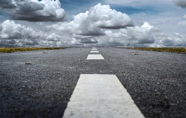 Open road with clouds. Stop Driver shortage with Retention Performer from sUperVision by Explore Information Services, a Solera Company